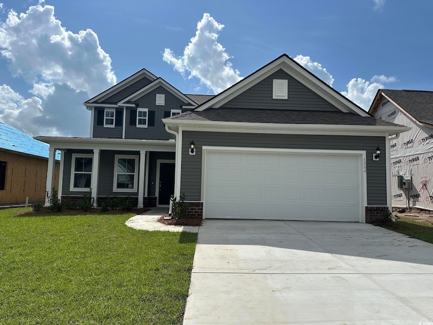 View of front facade with a garage and a front yar