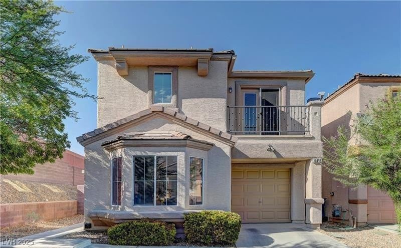 Traditional home featuring an attached garage, dri