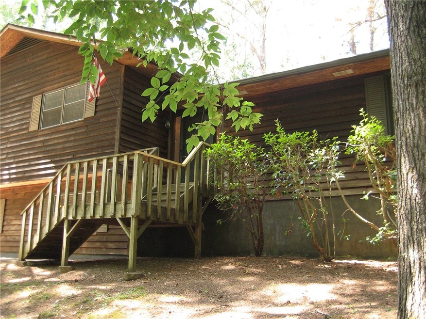 Front view of lake adjacent raised ranch