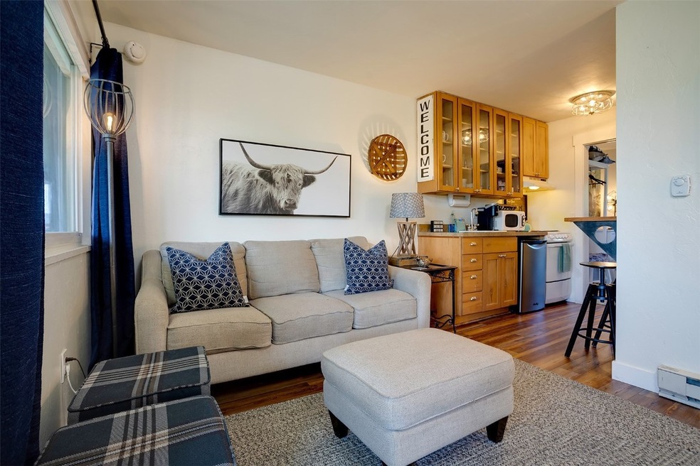 Living room featuring dark wood finished floors, b