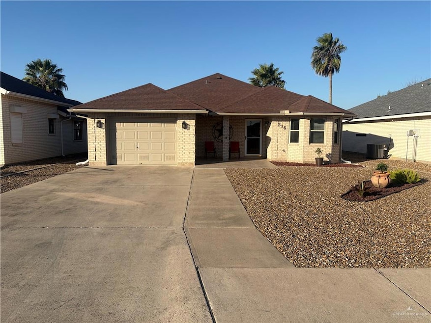 Ranch-style home featuring brick siding, driveway, an attached garage, and roof with shingles