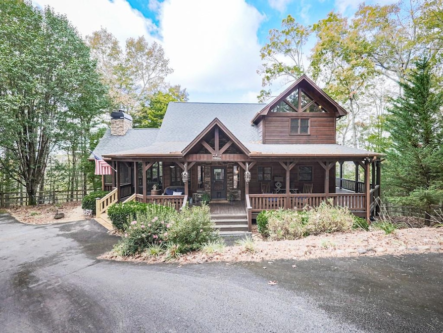 View of front facade featuring a porch, a chimney,