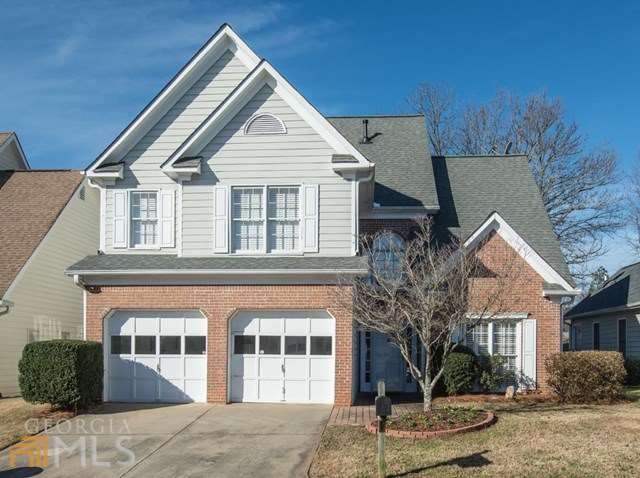 Rich brick and stone accents enhance the curb appe