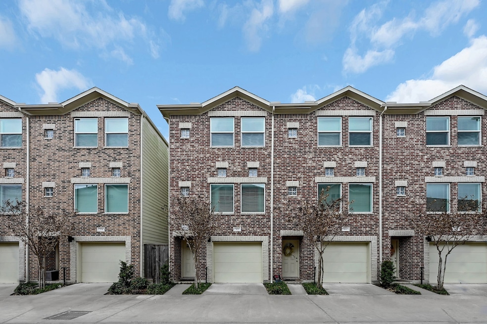 This photo shows a row of modern, three-story town