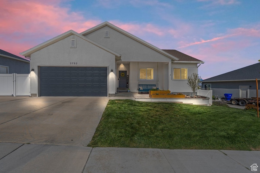 Ranch-style home featuring a porch, driveway, stucco siding, an attached garage, and a gate to the RV pad