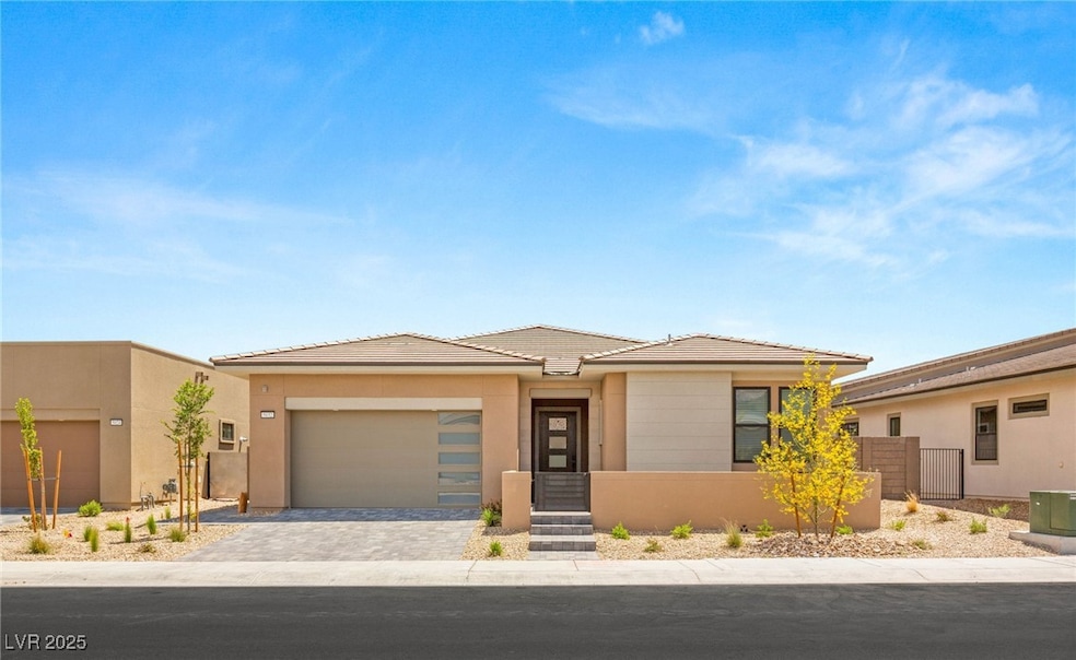 Prairie-style home featuring stucco siding, a tile