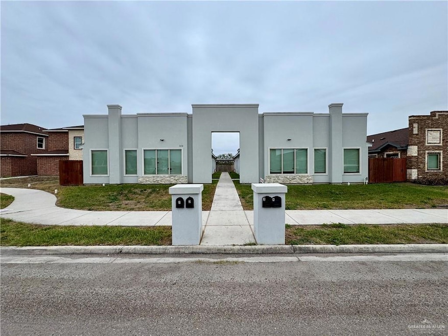 View of front facade featuring a front yard and stucco siding