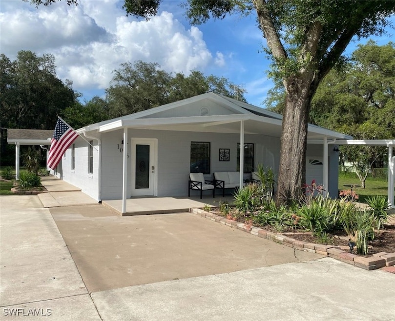 Back of property featuring concrete driveway