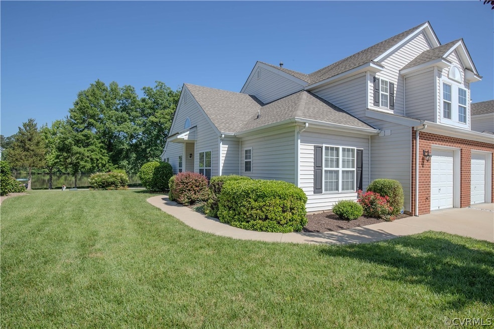 View of side of home with a garage and a lawn
