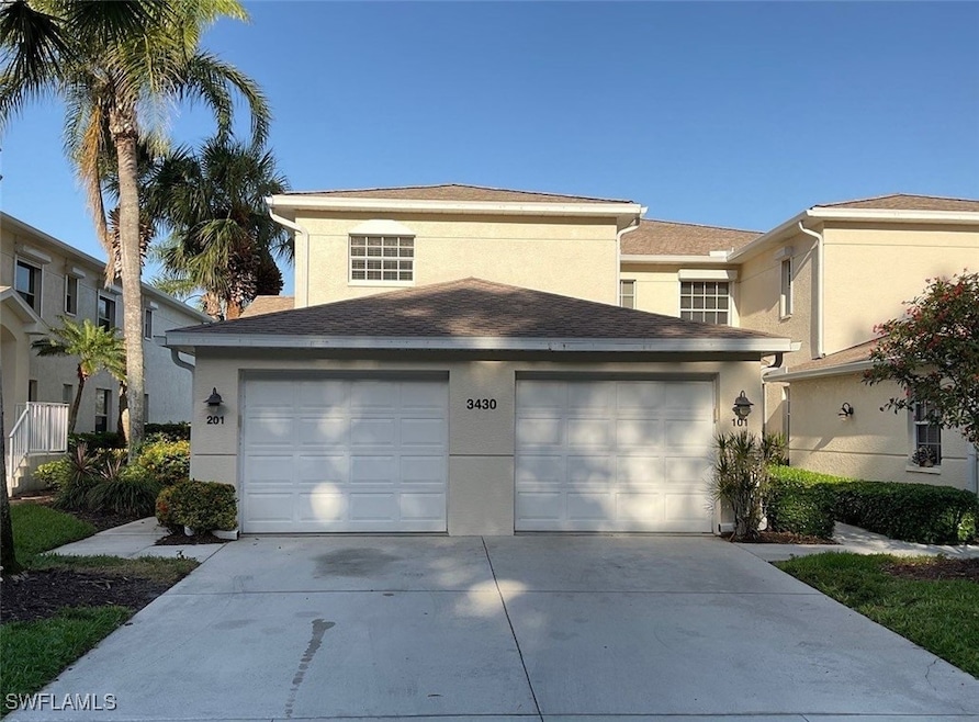 View of front of property featuring a garage, conc