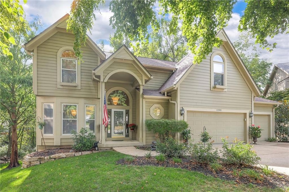 View of front of property with driveway, a front lawn, an attached garage, and a shingled roof