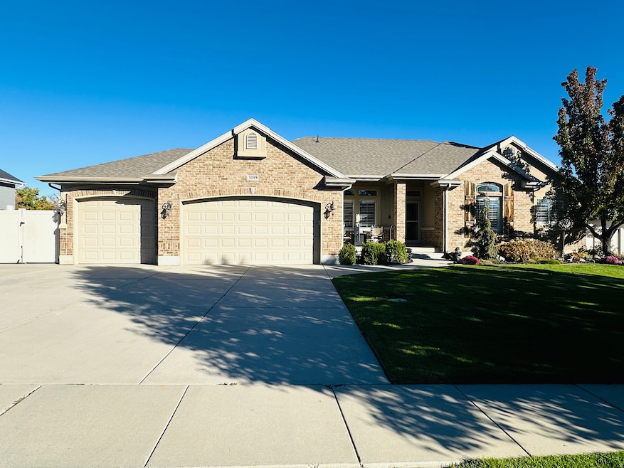 Ranch-style house featuring brick siding, a front yard, an attached garage, concrete driveway, and a porch