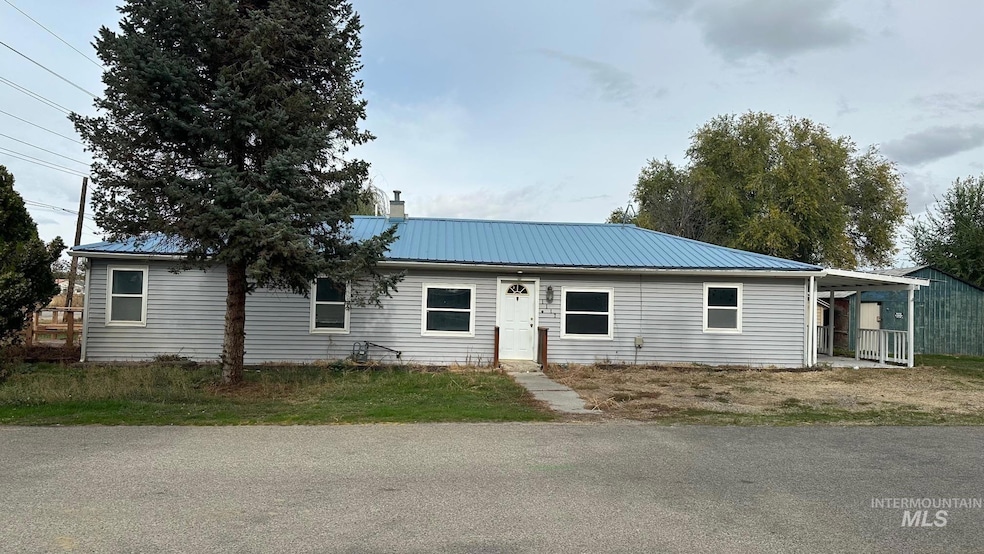 Ranch-style home featuring a metal roof and a chimney