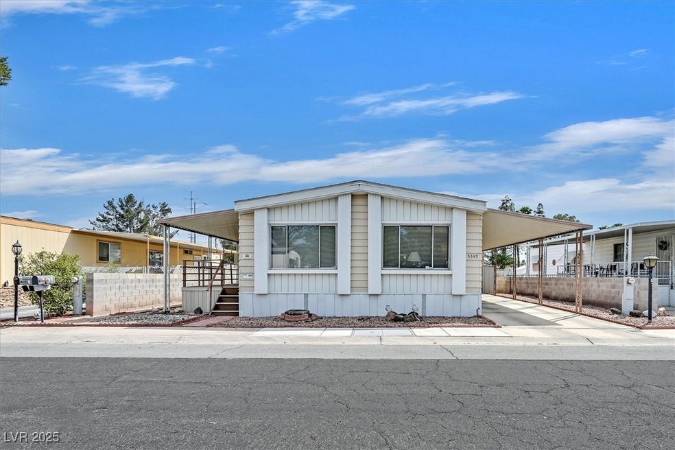 Manufactured / mobile home with a carport and fenc