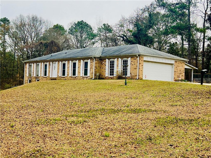 Ranch-style home with a garage and a front yard