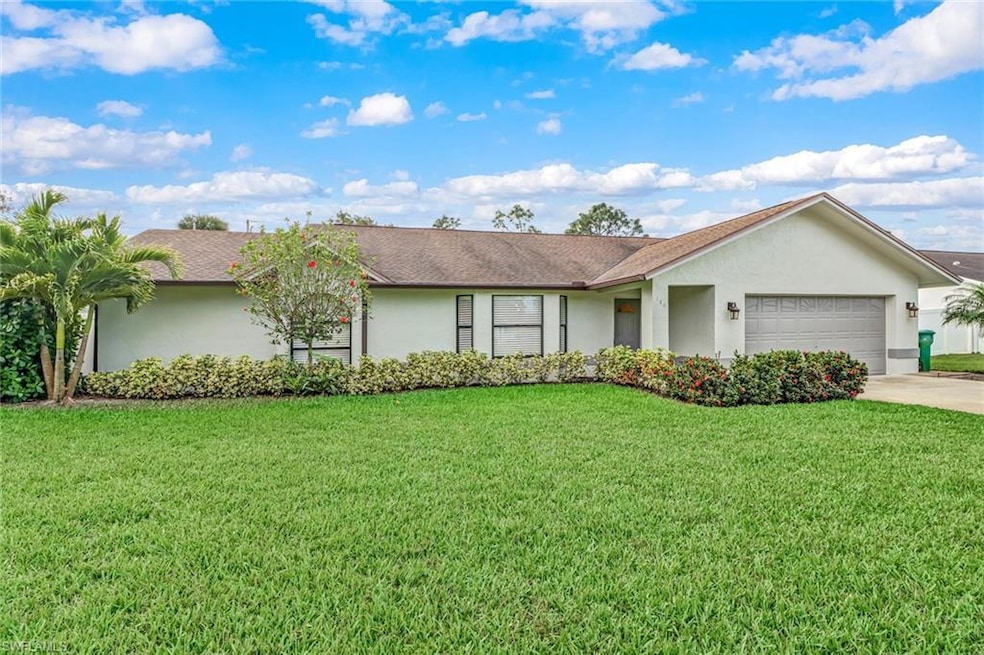 Ranch-style house featuring stucco siding, a front yard, a garage, roof with shingles, and concrete driveway