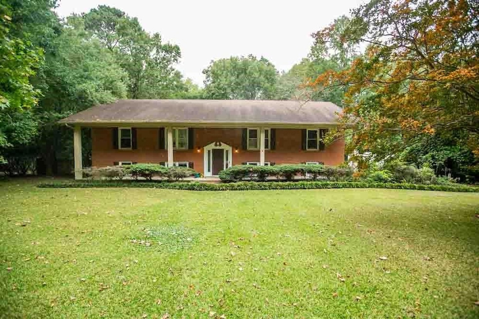 View of front of home with a porch and a front law