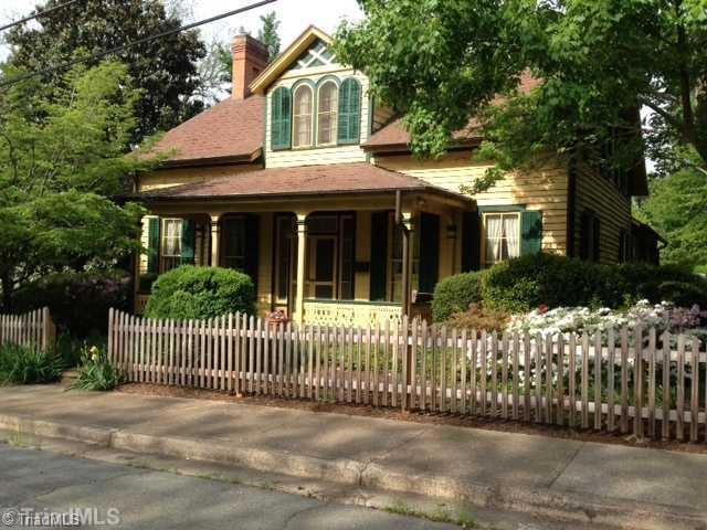 Exterior Front. Big Front Porch with Double Door Entry accented by Picket Fenced Landscaped Lot!