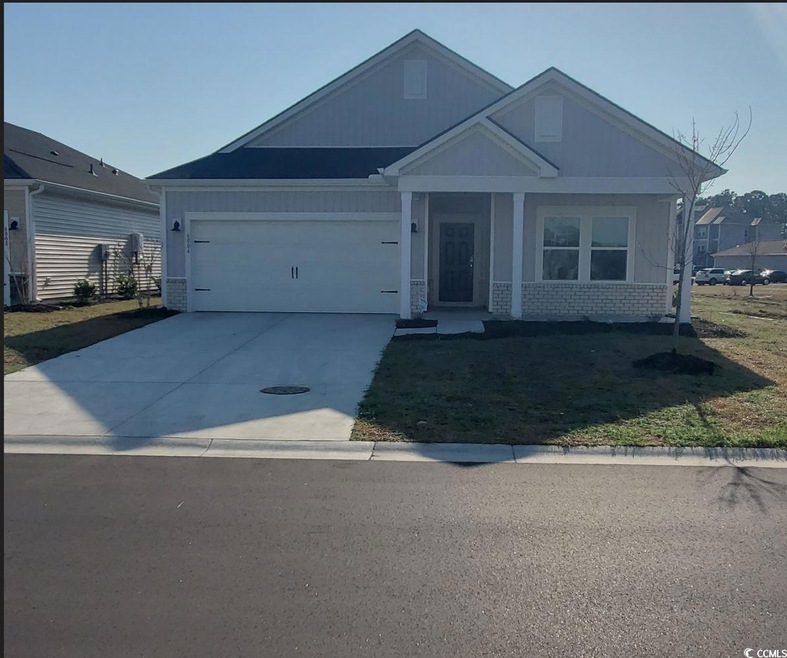 Ranch-style home with a garage, brick siding, a fr