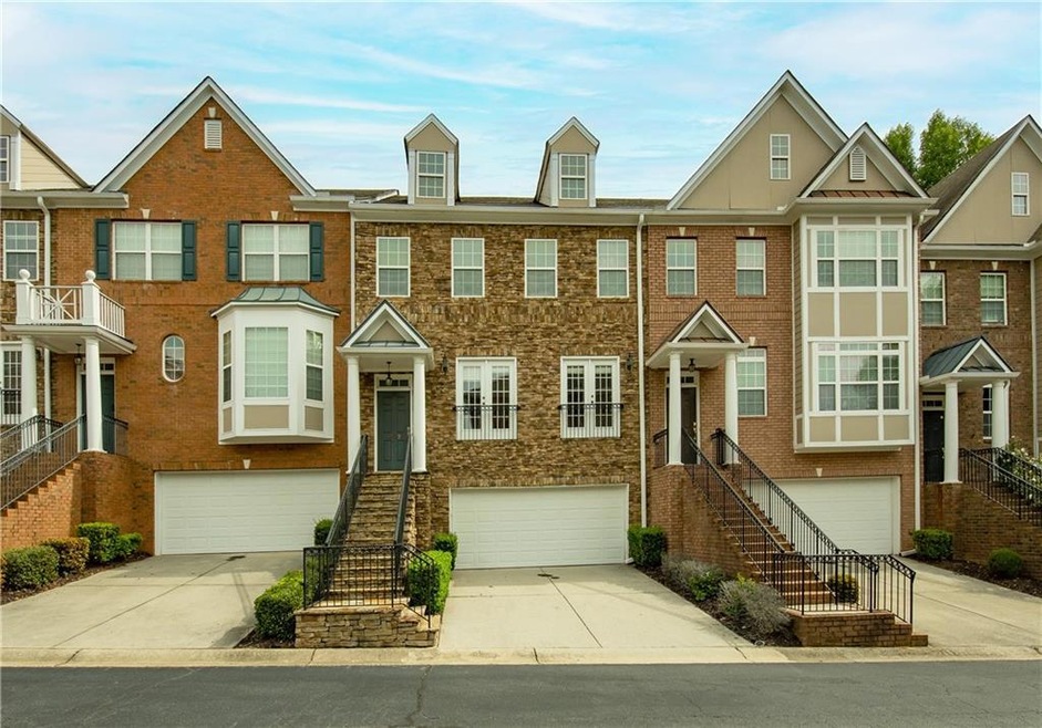 Townhome / multi-family property featuring a garag