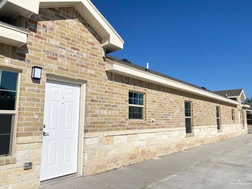 Doorway to property featuring brick siding