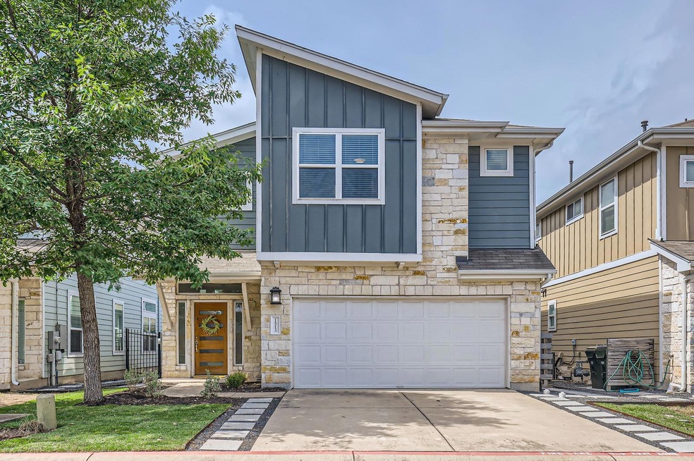 Modern home featuring board and batten siding, dr