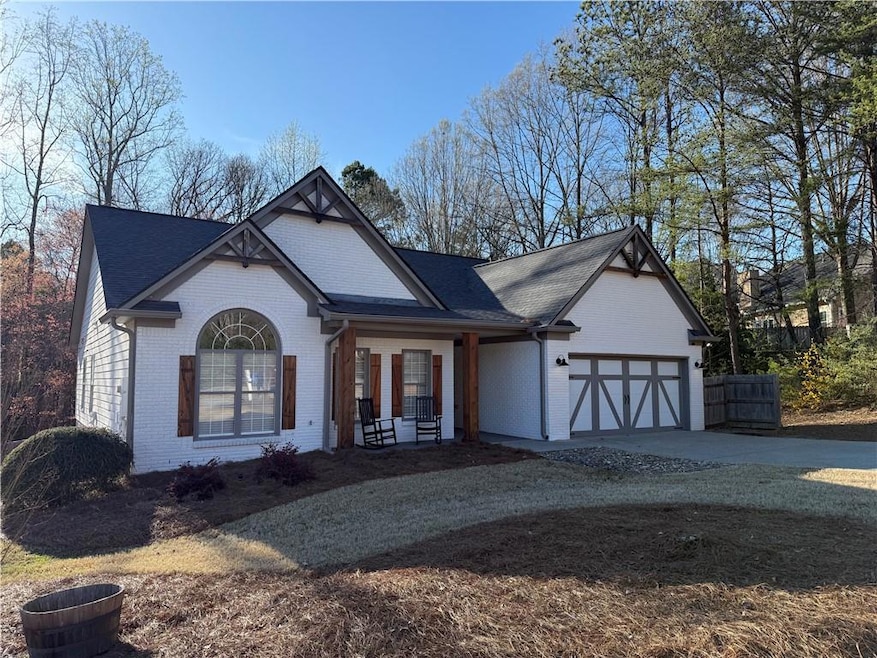View of front of home featuring a garage, brick si