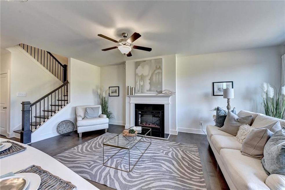 Living room with dark wood-type flooring and ceili