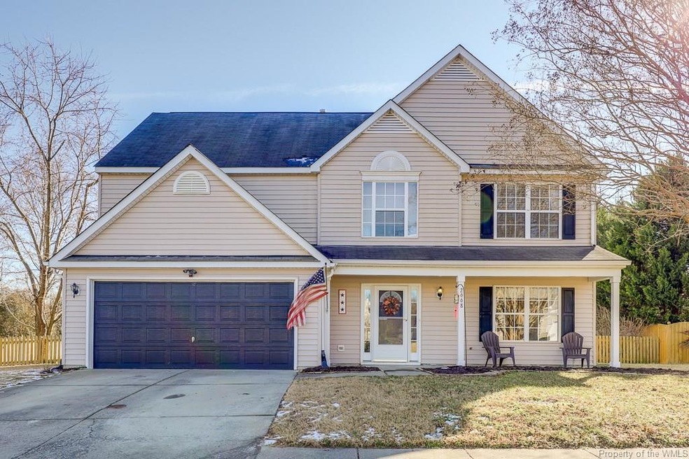 Front of house with view of entrance, garage door,