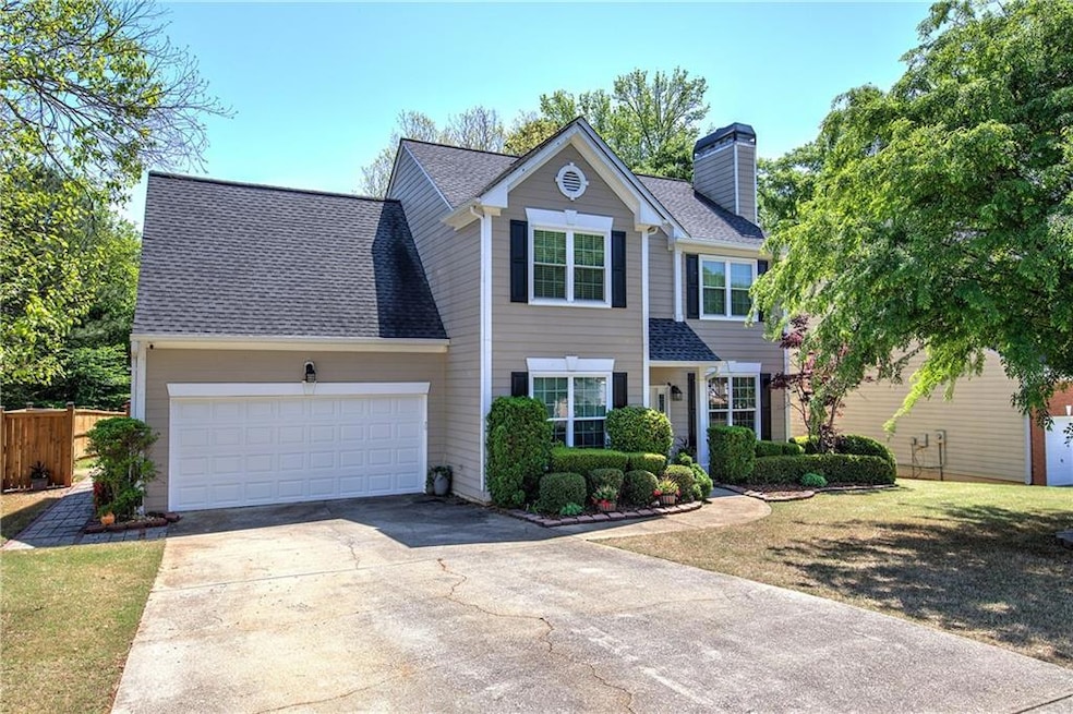 View of front of property featuring a chimney, dri
