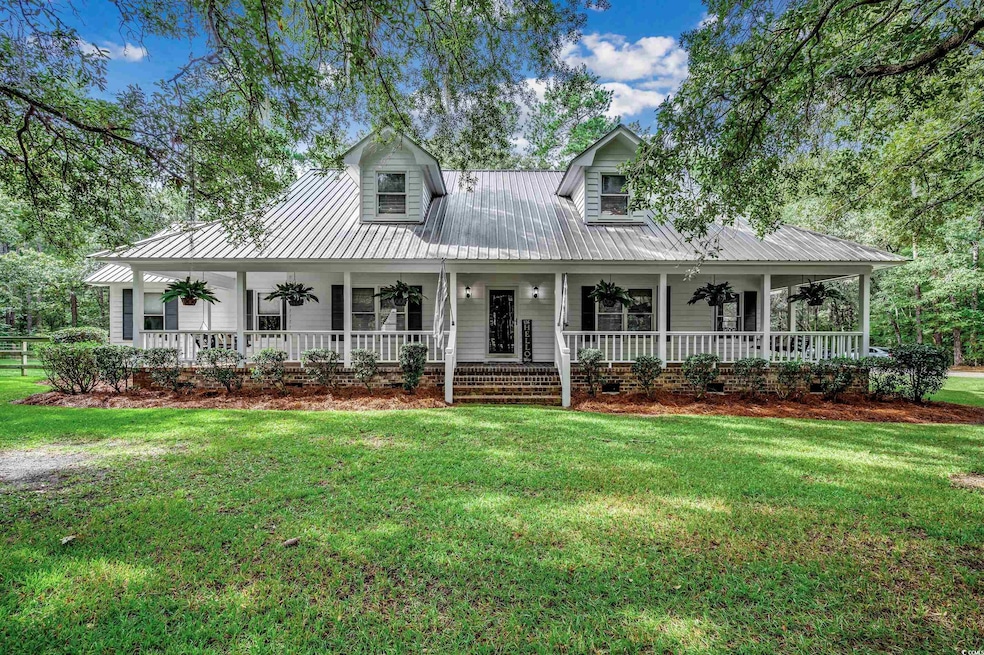 View of front of home with a porch, ceiling fan, a