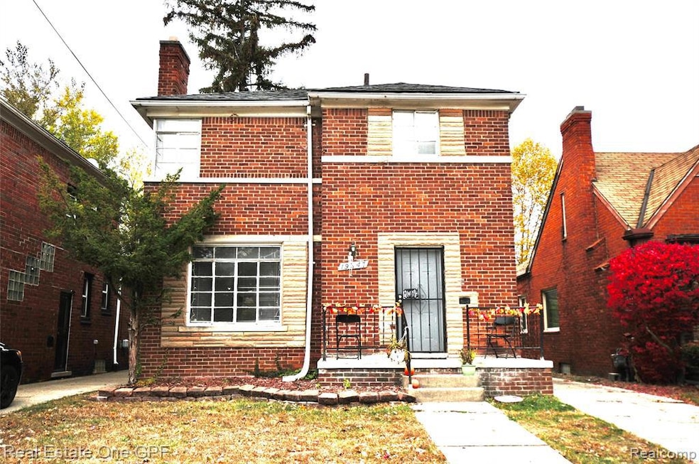 View of front of home featuring brick siding and a chimney
