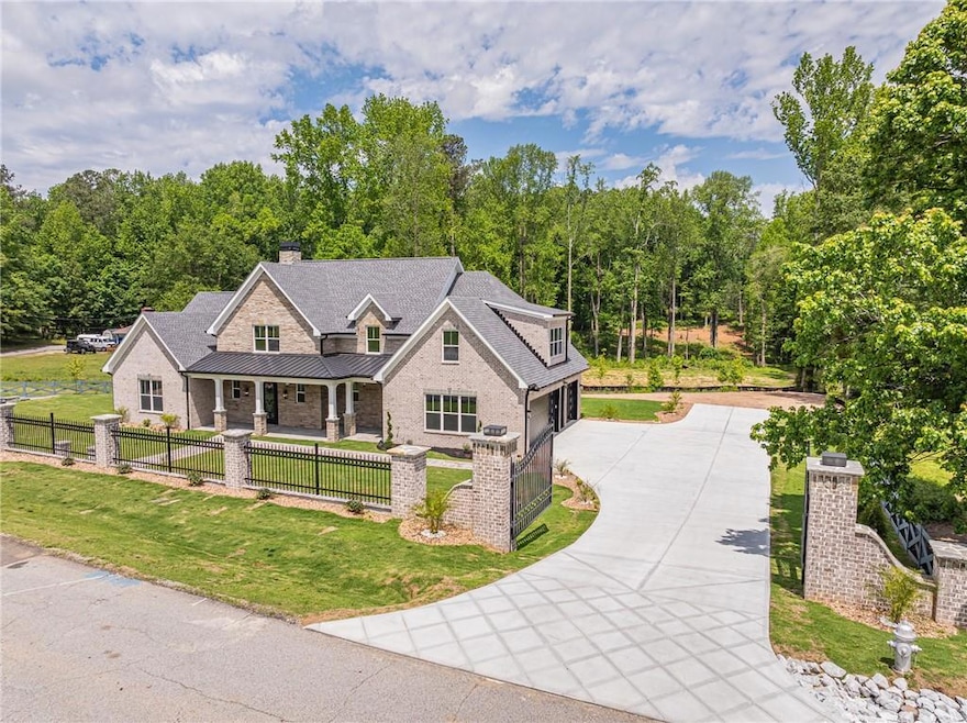 View of front of home with driveway, a porch, a st