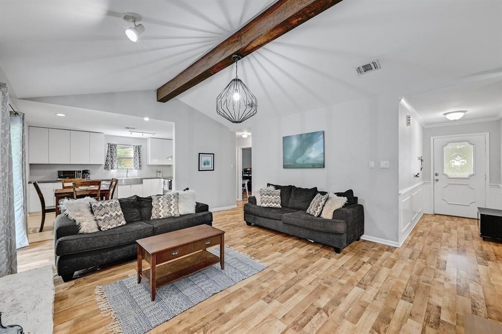 Enter into a bright open space with vaulted ceilings and large beam