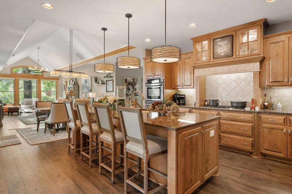 The kitchen is a culinary masterpiece, featuring a spacious center island, granite countertops, beautiful maple cabinets with tons of storage.  The open-concept design invites effortless conversation and connection from every room.