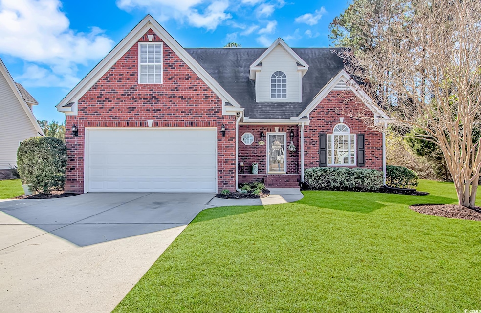 Front facade with a garage and a front lawn