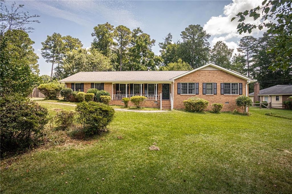 Ranch-style home with brick siding and covered porch