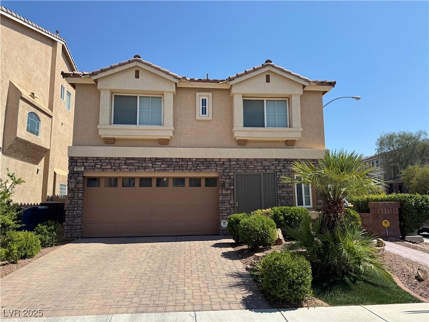 View of front of house with stucco siding, stone s