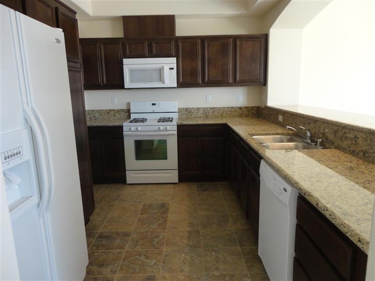 Large Kitchen with granite counter tops. Refrigera