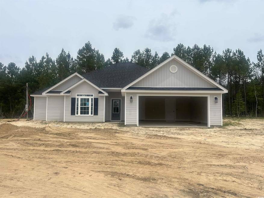View of front of home featuring a garage, driveway, and a shingled roof