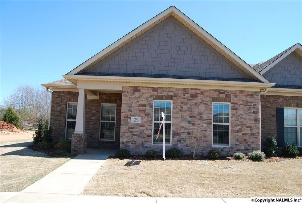 End of unit, larger than most at 1939 sq ft. 3 car rear entry garage with covered walkway, could easily be extended to make patio.