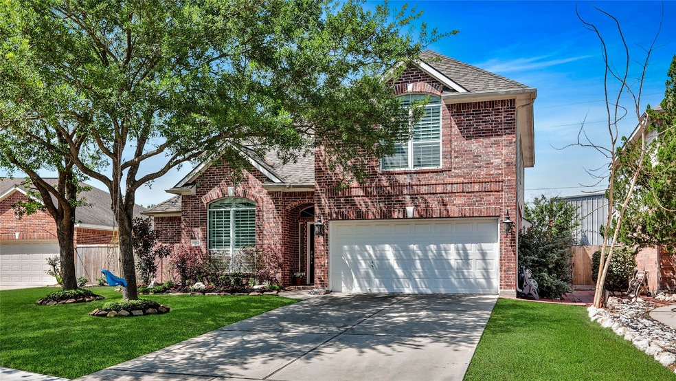 Welcome to 11734 Briar Canyon Ct.! A beautiful red brick and large elegant trees come together to create this wonderful front elevation.