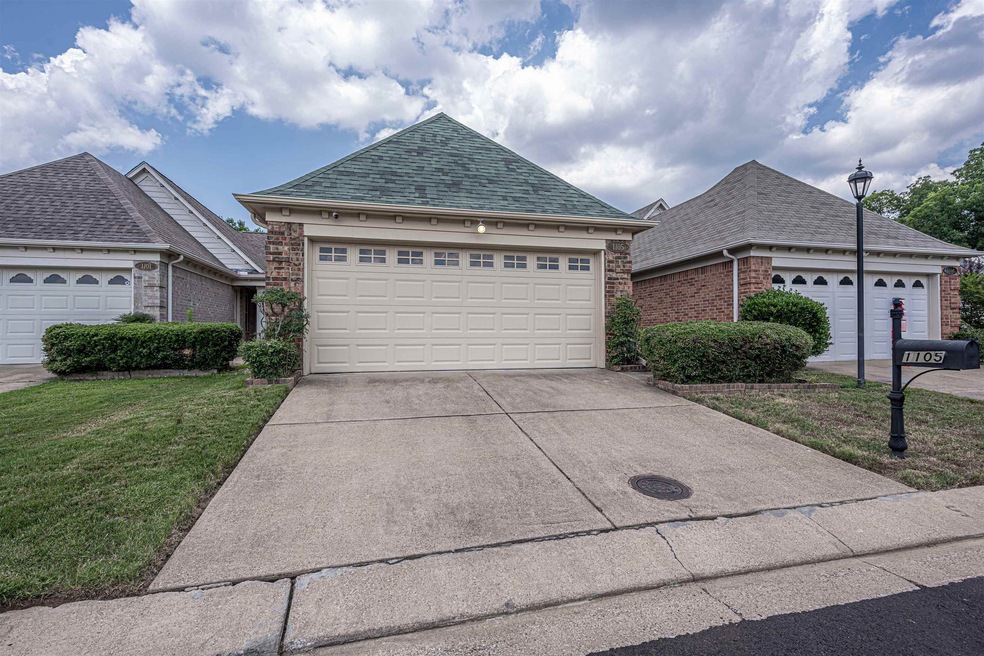 View of front facade with a garage and a front yar