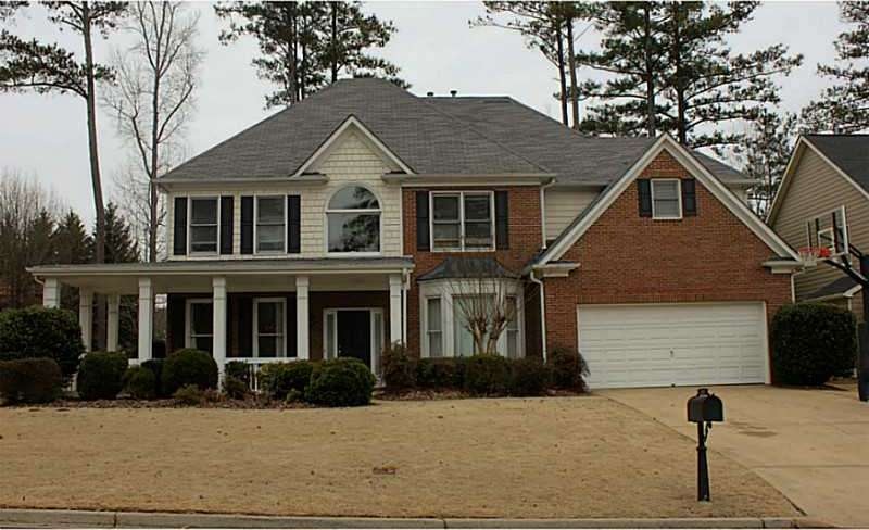 Exterior Front. Front porch, flat driveway on a fa