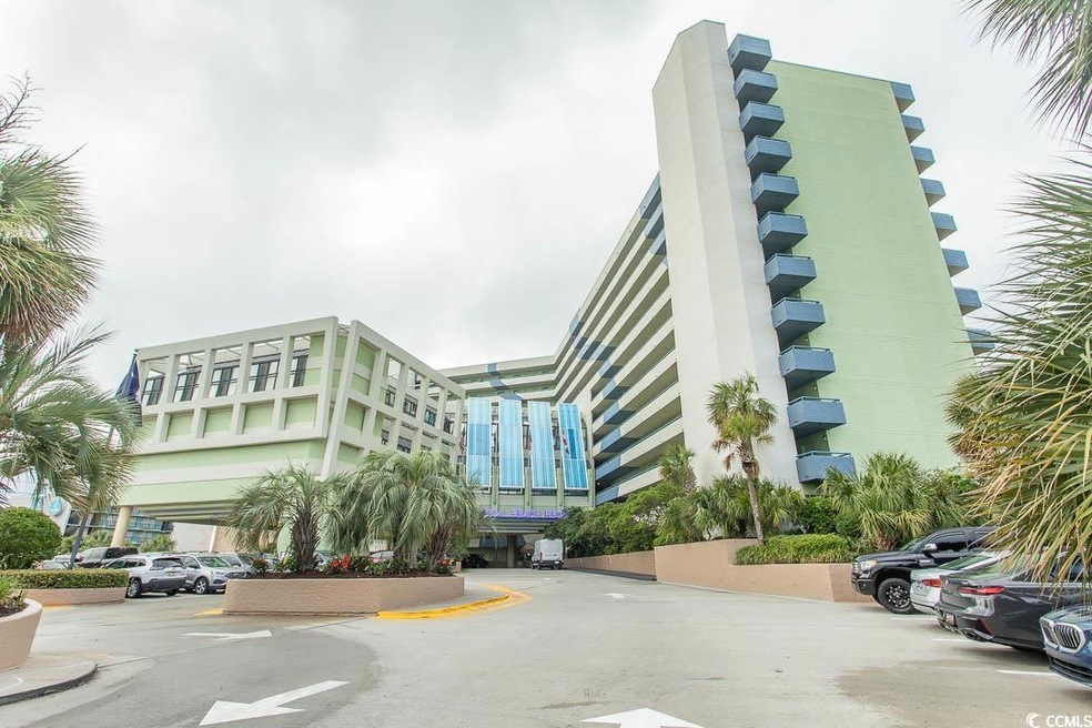 View of building exterior with uncovered parking