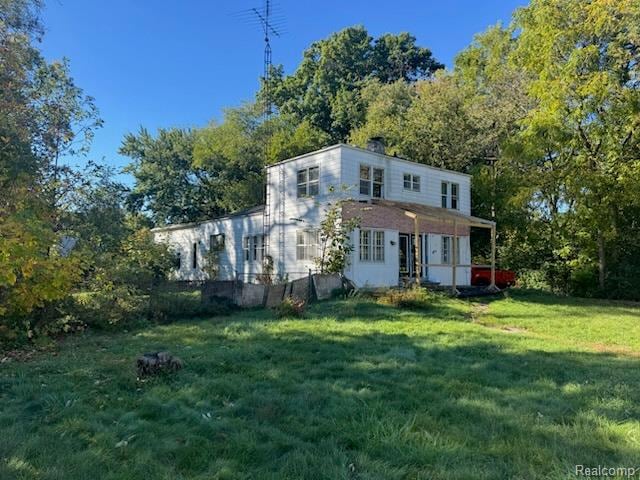 View of front of property with a front lawn and a chimney