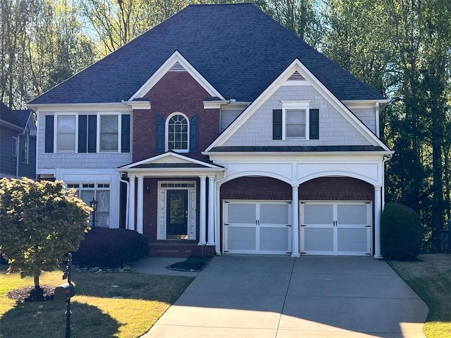 View of front of home featuring driveway, brick si
