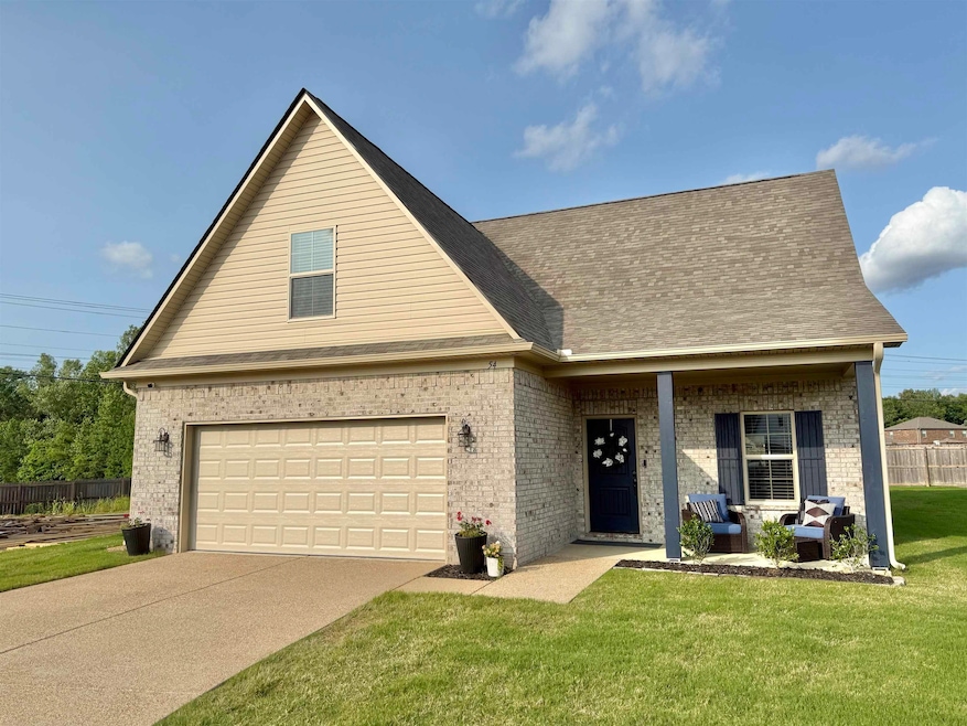 View of front facade featuring brick siding, concrete driveway, a porch, a garage, and roof with shingles