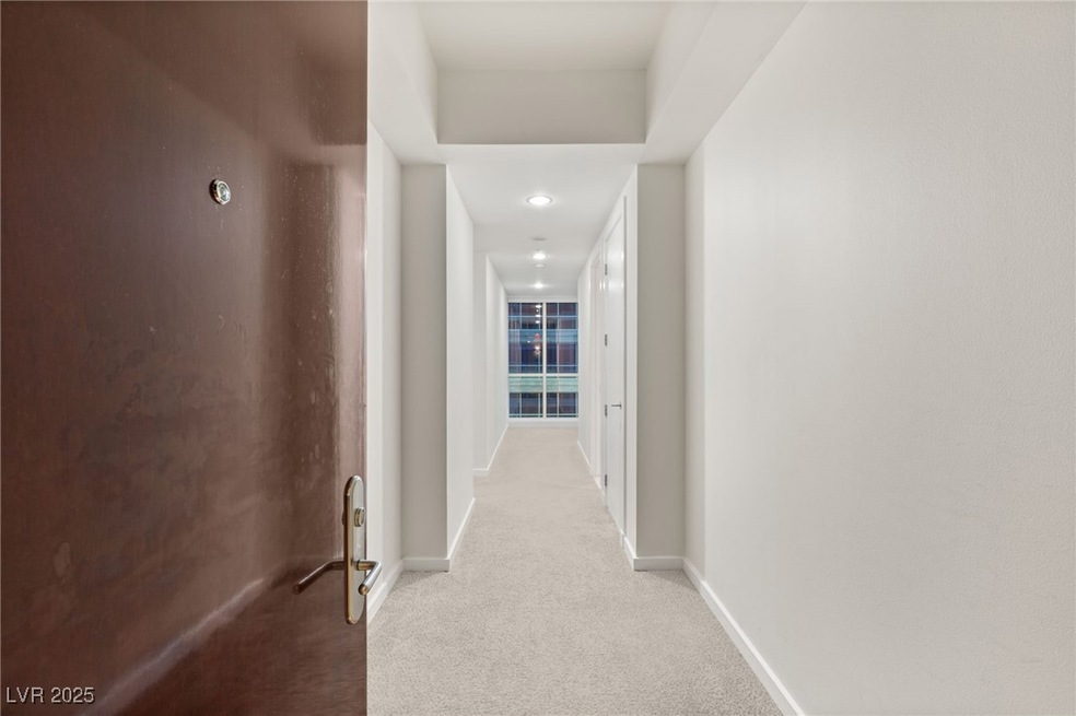 Hallway with carpet flooring and baseboards