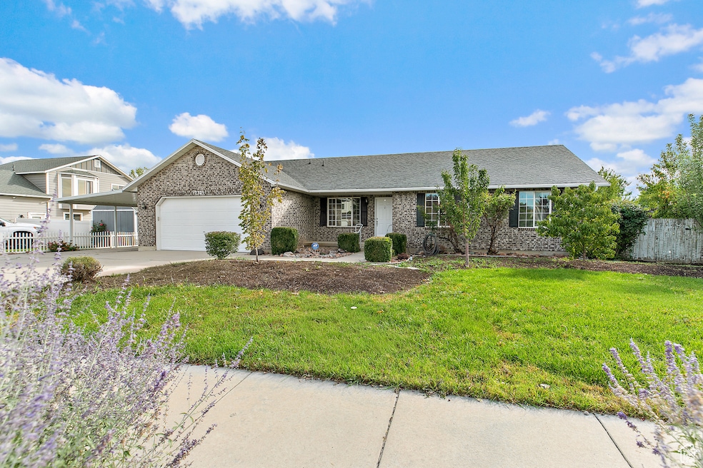 Ranch-style house with brick siding, concrete driveway, and an attached garage
